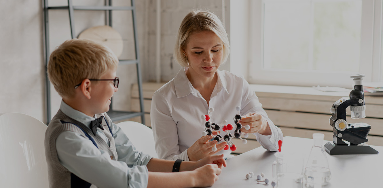 Female science tutor in San Bernardino studying chemistry with student