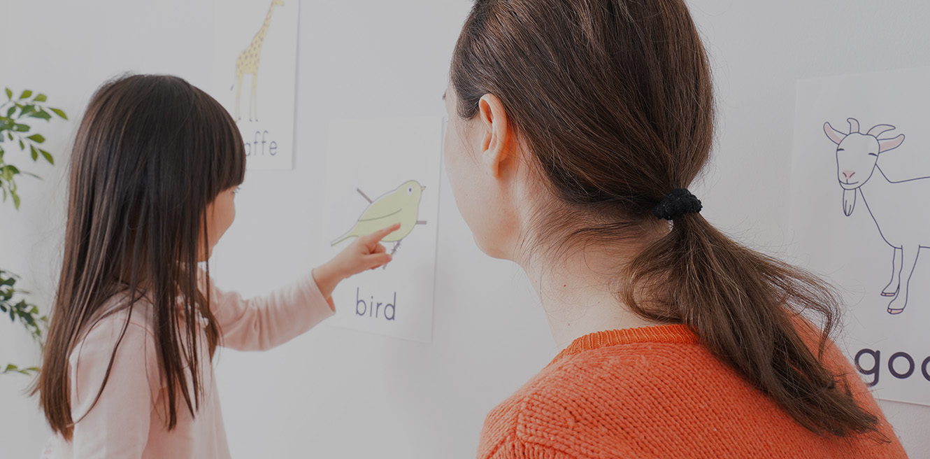 Female tutor reading words with young student